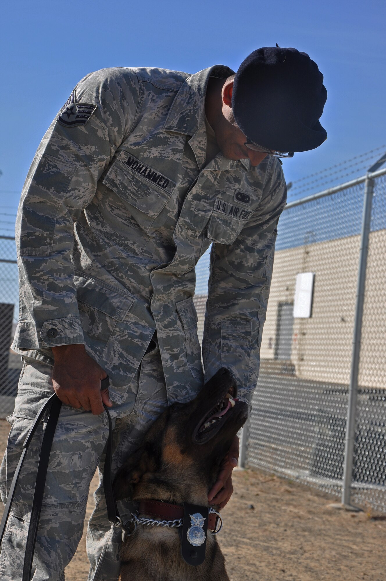 Staff Sgt. Zahir Mohammed, 60th Security Forces Squadron Military Working Dog handler, pets Borat Oct. 8 at the Travis MWD facility. During the Oct. 4 and 5 year-end Western States Police K-9 Association competition in South Lake Tahoe, Calif. Borat and Mohammed took first place in the vehicle competition and second place in the building competition. The Travis MWD team took first place overall in the final trial of the year. (U.S. Air Force photo/Senior Airman Madelyn Brown)