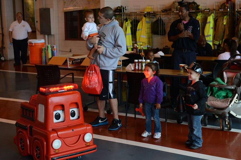 Children watch a “Freddie the Fire Truck” demonstration at the fire department during an open house at Fort Eustis, Va., Oct. 12, 2013. During the open house, children were taught how to dial 911, given a fire-truck tour and shown basic life-saving skills. (U.S. Air Force photo by Staff Sgt. Ciara Wymbs/Released) 