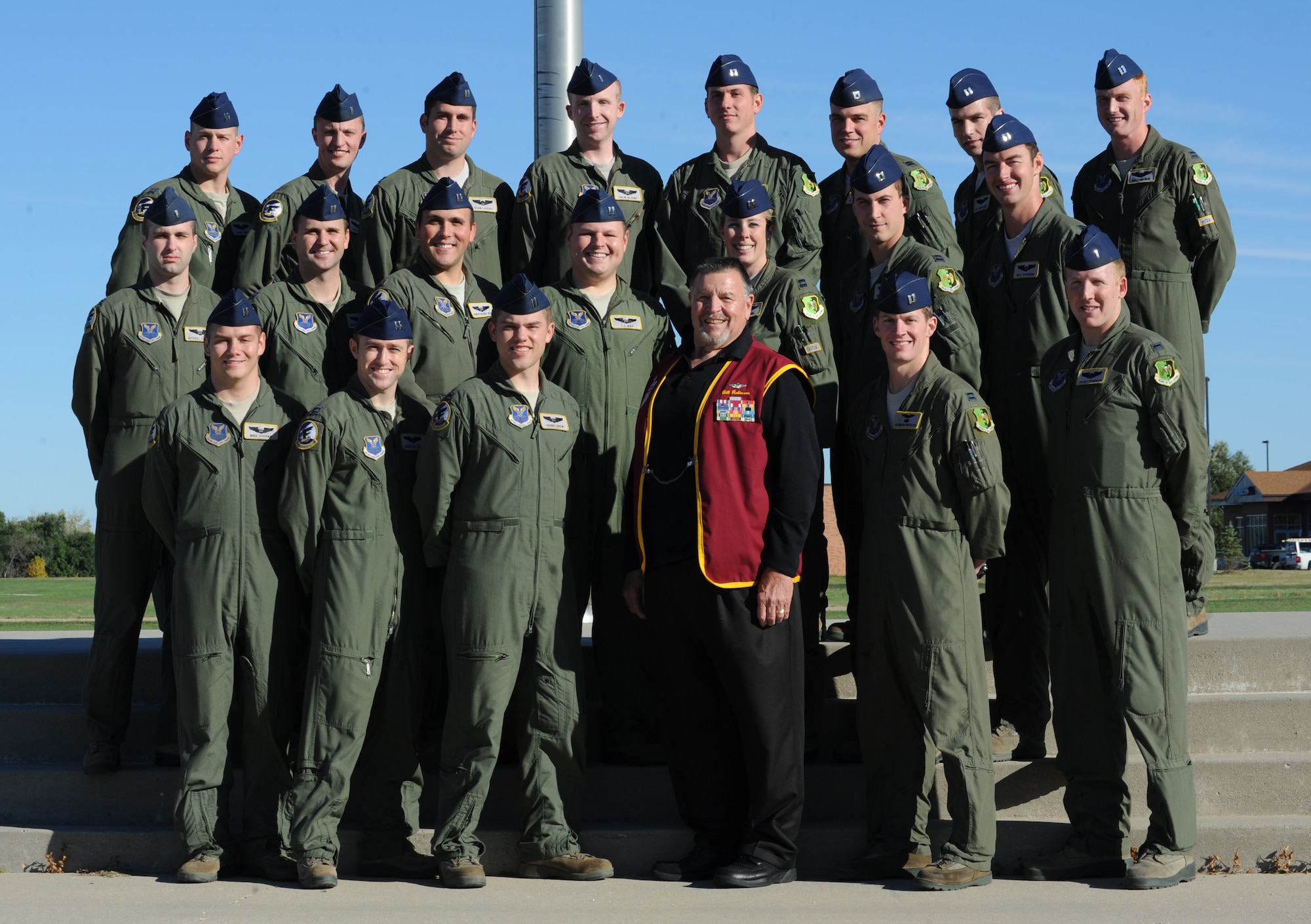 Retired Air Force captain Bill Robinson (Center) stands with members of the 69th Bomb Squadron at Minot Air Force Base, N.D. For eight Thanksgivings, Christmas', and New Years', more than seven and a half years, and a total of 2,703 days, Robinson was held in captivity by enemy forces in North Vietnam. (U.S. Air Force photo/Senior Airman Stephanie Sauberan)