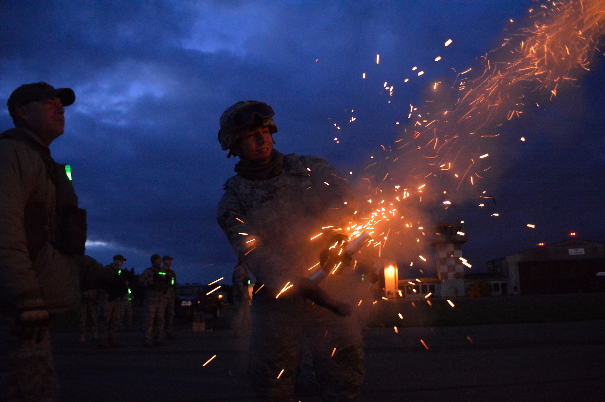 Airman 1st Class David Vasquez, 355th Security Forces Squadron creek defender course trainee, fires a slap flare during a night combat tactics class, Oct. 15, 2013, Baumholder Air Field, Germany. Vasquez was part of a 98-student class undergoing training to prepare them for deployed conditions around the world. (U.S. Air Force photo/Airman 1st Class Jordan Castelan)