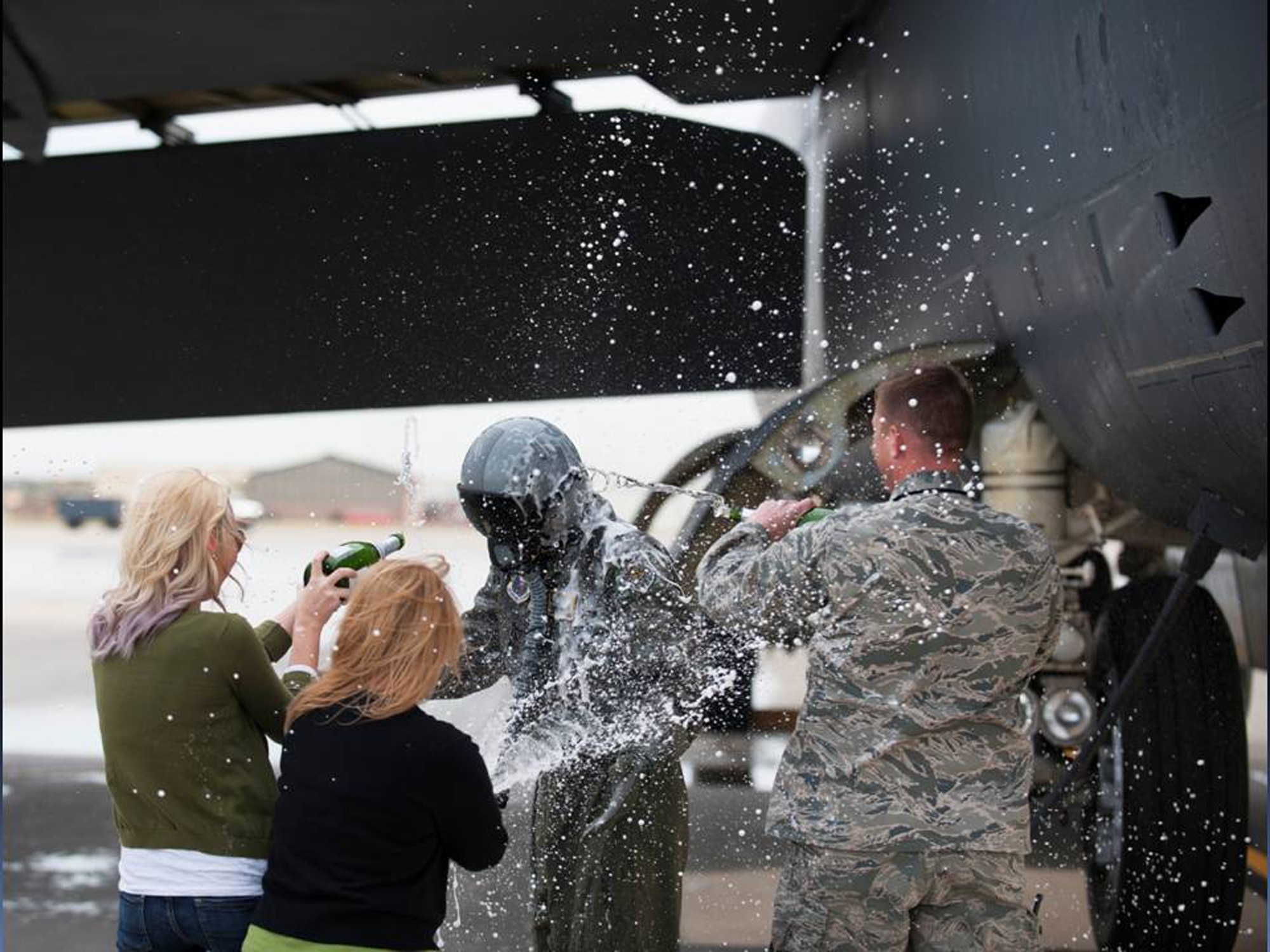Col. Max B. Mitchell gets dosed with water and celebration by his family and Col. Alex Mezynski, commander of the 5th Bomb Wing, after Mitchell’s final flight in the B-52H Stratofortress, Oct. 8. Mitchell officially retired from the U.S. Air Force, Oct. 11, after 25 years of service with nearly 4,000 flying hours in the B-52 as a master navigator. (U.S Air Force photo/Capt. Jeffre Nagan)