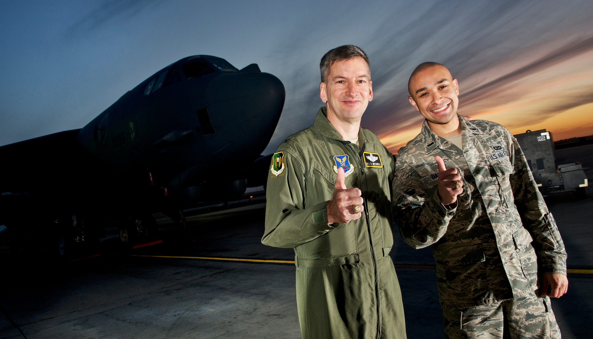 Col. Max B. Mitchell and 1st Lt. Jose R. Davis hoist a Fightin’ Texas Aggie “Gig’em” in front of a B-52H Stratofortress, Oct. 9. After serving as vice wing commander of the 5th Bomb Wing, Mitchell officially retired from the U.S. Air Force Friday, Oct. 11. Mitchell has 25 years of service with nearly 4,000 flying hours in the B-52 as a master navigator. (U.S Air Force photo/Tech. Sgt. Aaron Allmon)