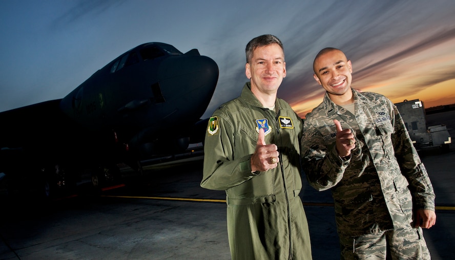 Col. Max B. Mitchell and 1st Lt. Jose R. Davis hoist a Fightin’ Texas Aggie “Gig’em” in front of a B-52H Stratofortress, Oct. 9. After serving as vice wing commander of the 5th Bomb Wing, Mitchell officially retired from the U.S. Air Force Friday, Oct. 11. Mitchell has 25 years of service with nearly 4,000 flying hours in the B-52 as a master navigator. (U.S Air Force photo/Tech. Sgt. Aaron Allmon)