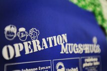 Operation Mugs and Hugs was hosted at the Dakota Square Mall in Minot, N.D., Oct. 12, as a way to help promote safety throughout the Minot community. At the event parents were given identification kits that included ink for the finger prints, medical information, DNA hair sample and other personal information that would assist law enforcement officers during abduction investigations. (U.S. Air Force photo/Senior Airman Jose L. Hernandez)