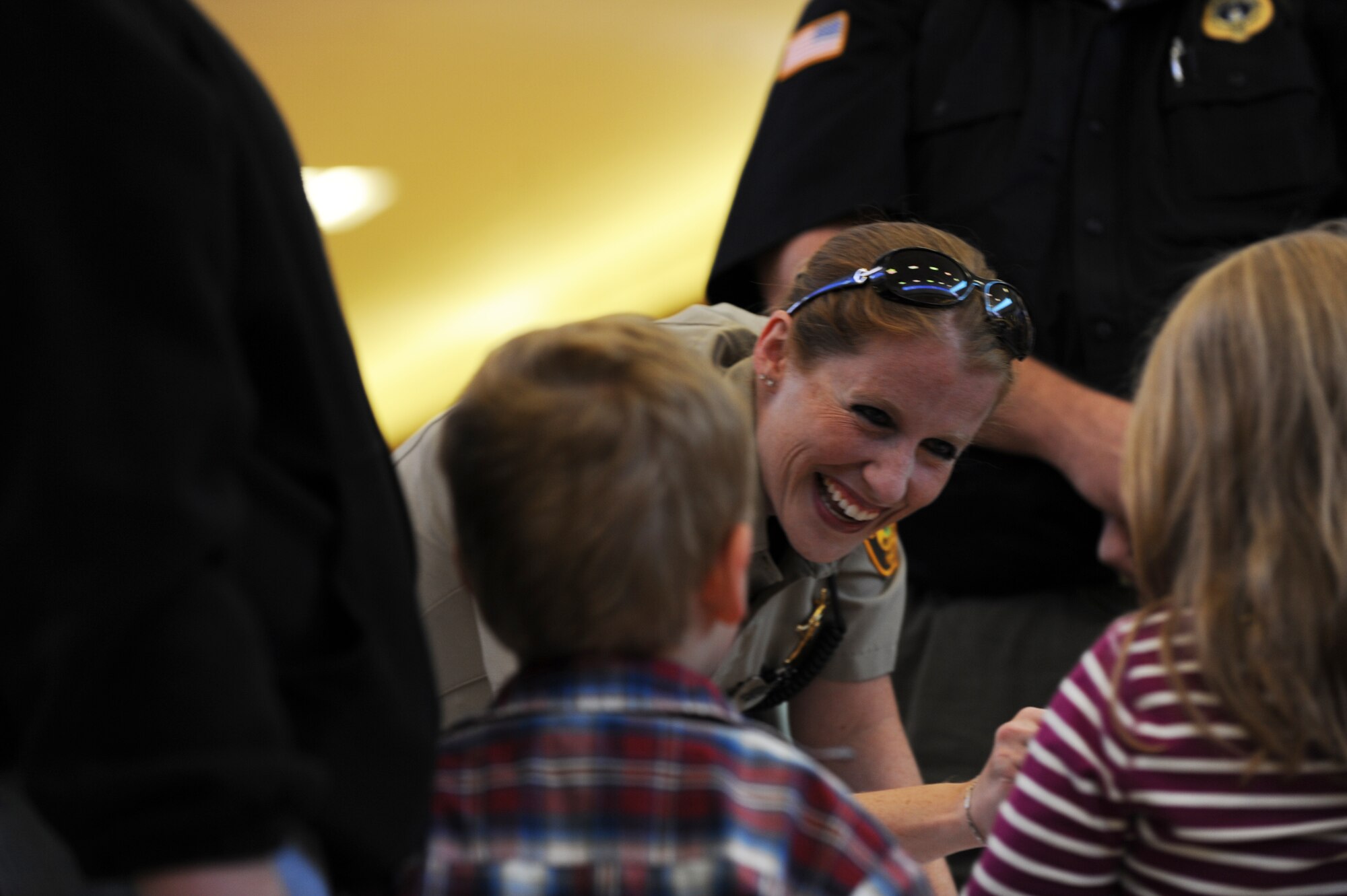A Ward County Sherriff’s Deputy interacts with children about the importance of staying out of trouble, during the Minot Police Department’s Operation Mugs and Hugs hosted in Minot, N.D., Oct. 12. With assistance from various community organizations, as well as Team Minot Airmen, Minot PD officers provided children with stickers, bags, utensils and other memorabilia promoting community safety tips. (U.S. Air Force photo/Senior Airman Jose L. Hernandez)