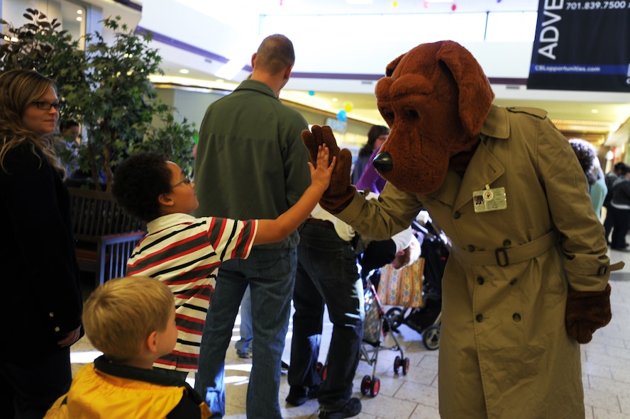 McGruff the Crime Dog greets children during the Minot Police Department’s Operation Mugs and Hugs hosted in Minot, N.D., Oct. 12. Minot Air Force Base’s 5th Security Forces Squadron, along with other volunteers from base provided support for the event. (U.S. Air Force photo/Senior Airman Jose L. Hernandez)