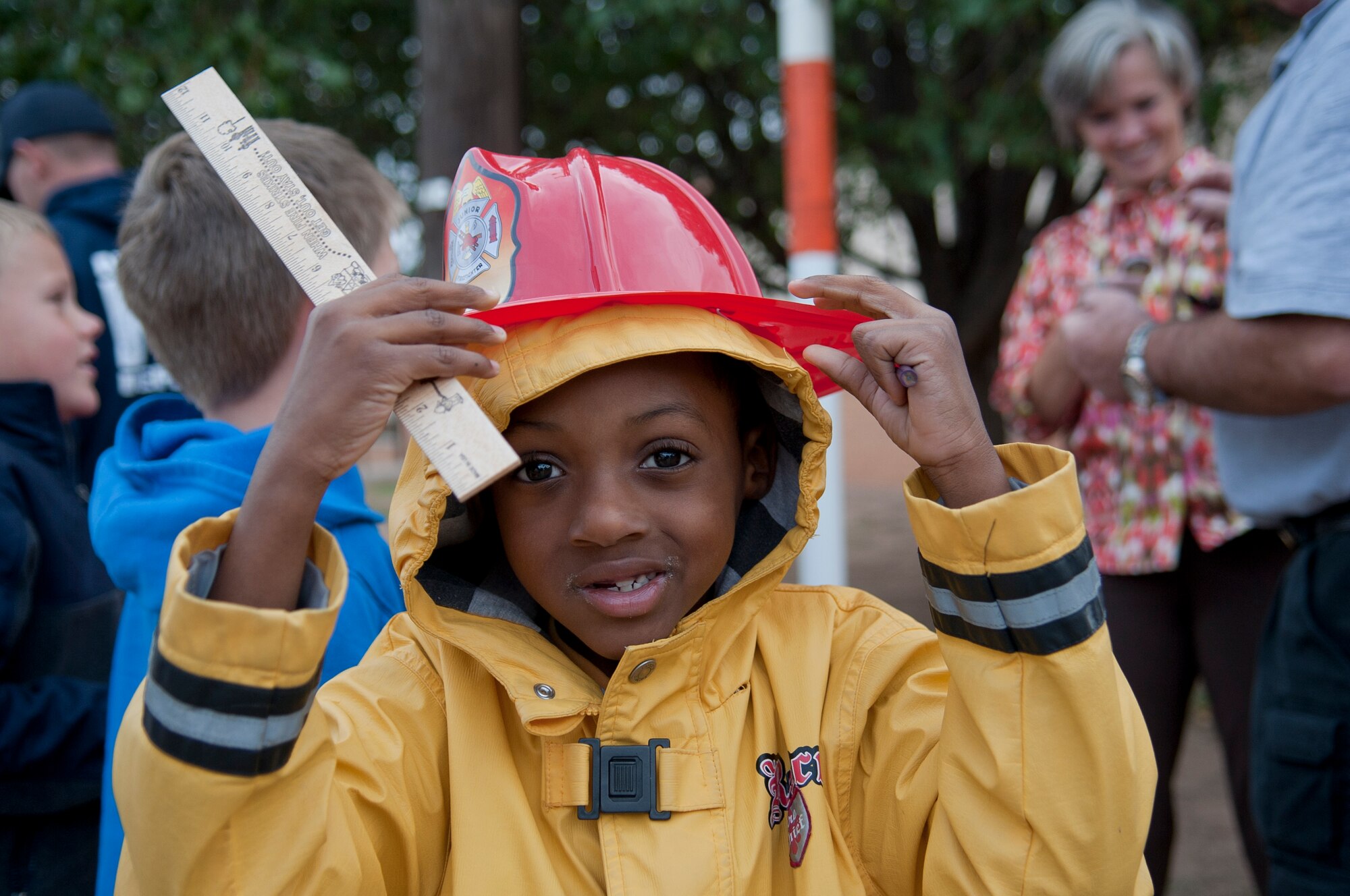 ALTUS AIR FORCE BASE, Okla. – Micah Palmer, son of Tech. Sgt. Marcus Palmer, 97th Operations Support Squadron, puts on a fire department-style hat after the house-fire prevention training Oct. 15. The children were taught basic fire response and prevention skills to improve safety throughout the community. (U.S. Air Force photo by Senior Airman Dillon Davis/Released)