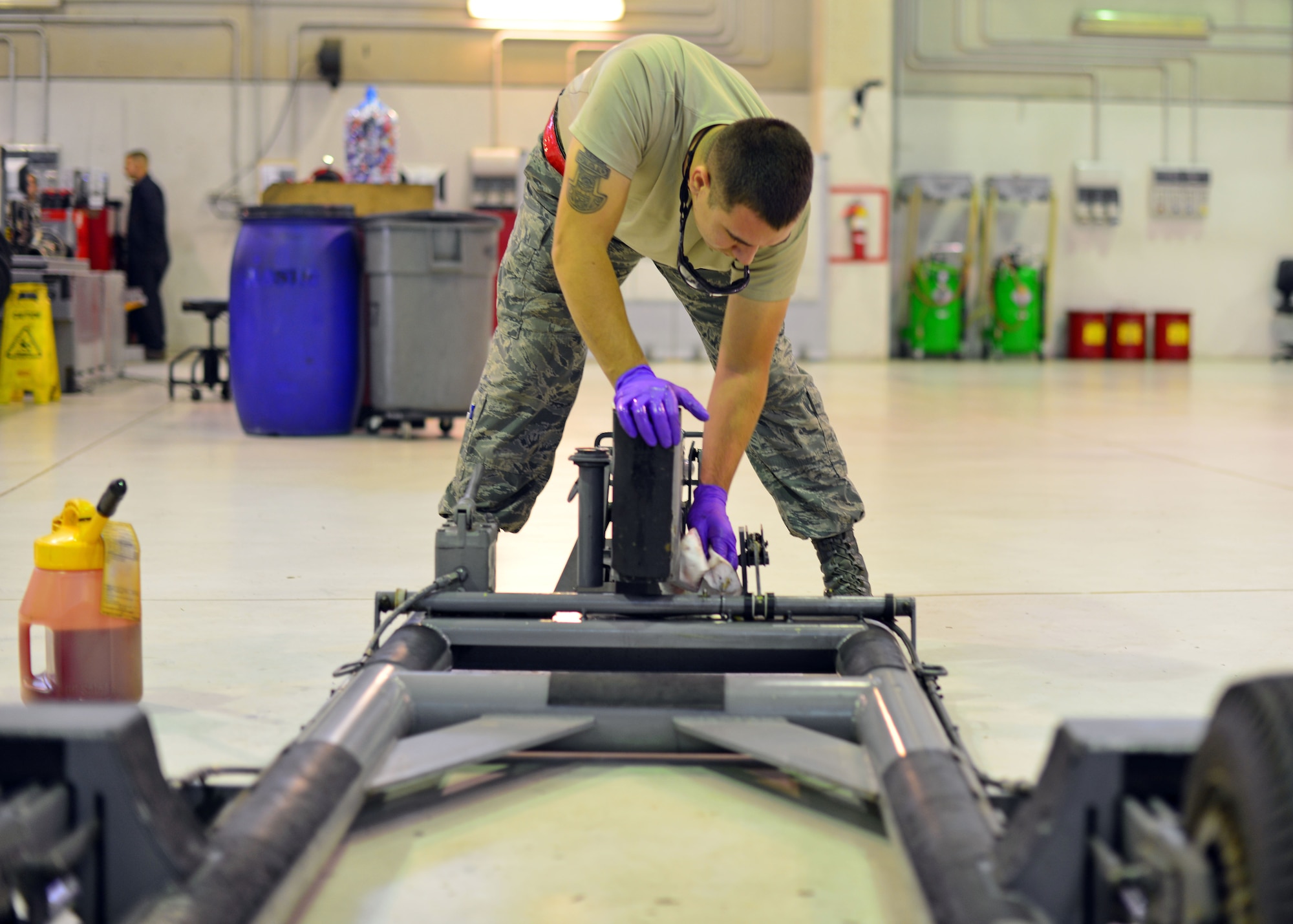 Airman 1st Class Vincent Obregon, 31st Maintenance Squadron aerospace ground equipment journeyman, wipes down a dolley, Oct. 10, 2013, at Aviano Air Base, Italy. AGE Airmen encompass a variety of technical skills, such as electronic, air conditioning and hydraulic technical skills, which they learn during technical training before arriving on the job. (U.S. Air Force photo/Senior Airman Briana Jones)