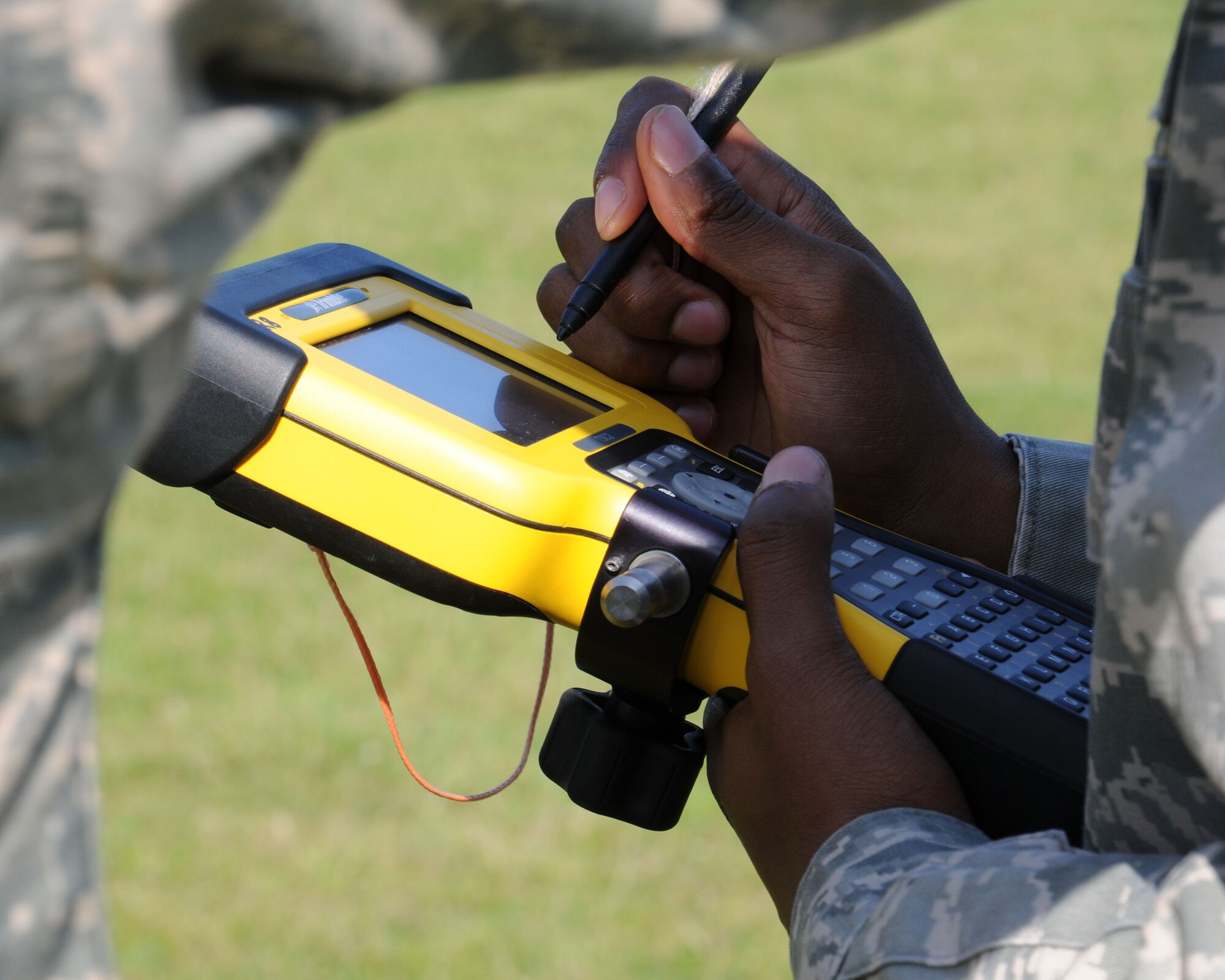 U.S. Air Force Staff Sgt. Erik Holloman, 100th Civil Engineer Squadron NCO in charge of geobase from Washington, D.C., uses a survey controller Sept. 27, 2013, on RAF Mildenhall, England. The 100th CES Engineer Assistants shop provides mapping, drafting and surveying support to keep the installation base map up-to-date. The shop personnel design and maintain floor plans, and make sure all utilities and infrastructure are properly geo-referenced to their exact coordinate system. (U.S. Air Force photo by Gina Randall/Released)