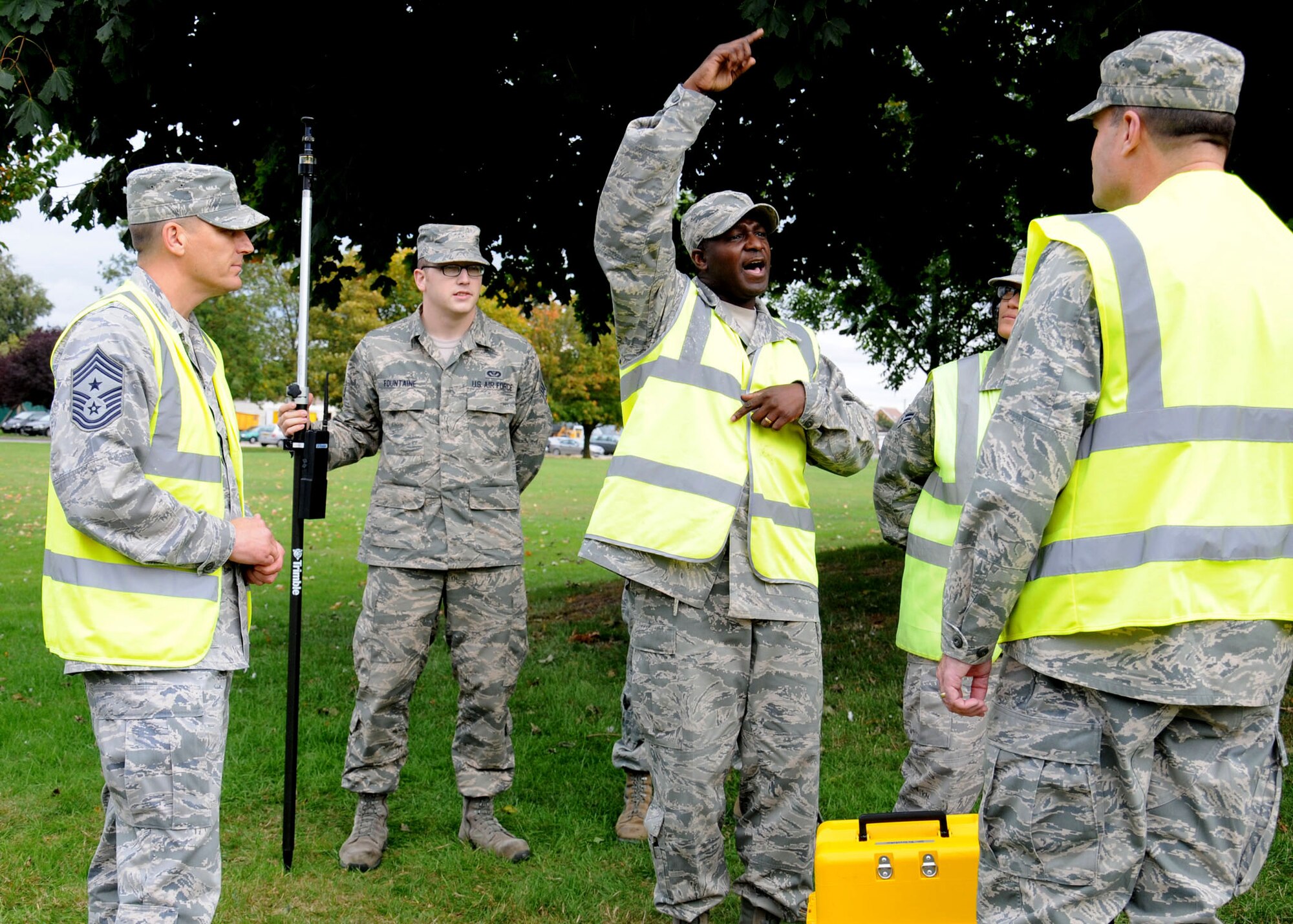 U.S. Air Force Master Sgt. Solomon Vincent, center, 100th Civil Engineer Squadron Programs Flight superintendent from Bladensburg, Md., explains how to use a geodimeter to U.S. Air Force Col. Kenneth T. Bibb Jr., right, 100th Air Refueling Wing commander, and U.S. Air Force Chief Master Sgt. Tracy Jones, 100th ARW command chief, Oct. 9, 2013, on RAF Mildenhall, England. Members of the 100th ARW leadership visited the 100th CES Engineer Assistants shop as part of the “dirty jobs” program. Vincent explained how the 100th CES Engineer Assistants shop provides mapping, drafting and surveying support to maintain the installation base map. (U.S. Air Force photo by Gina Randall/Released)