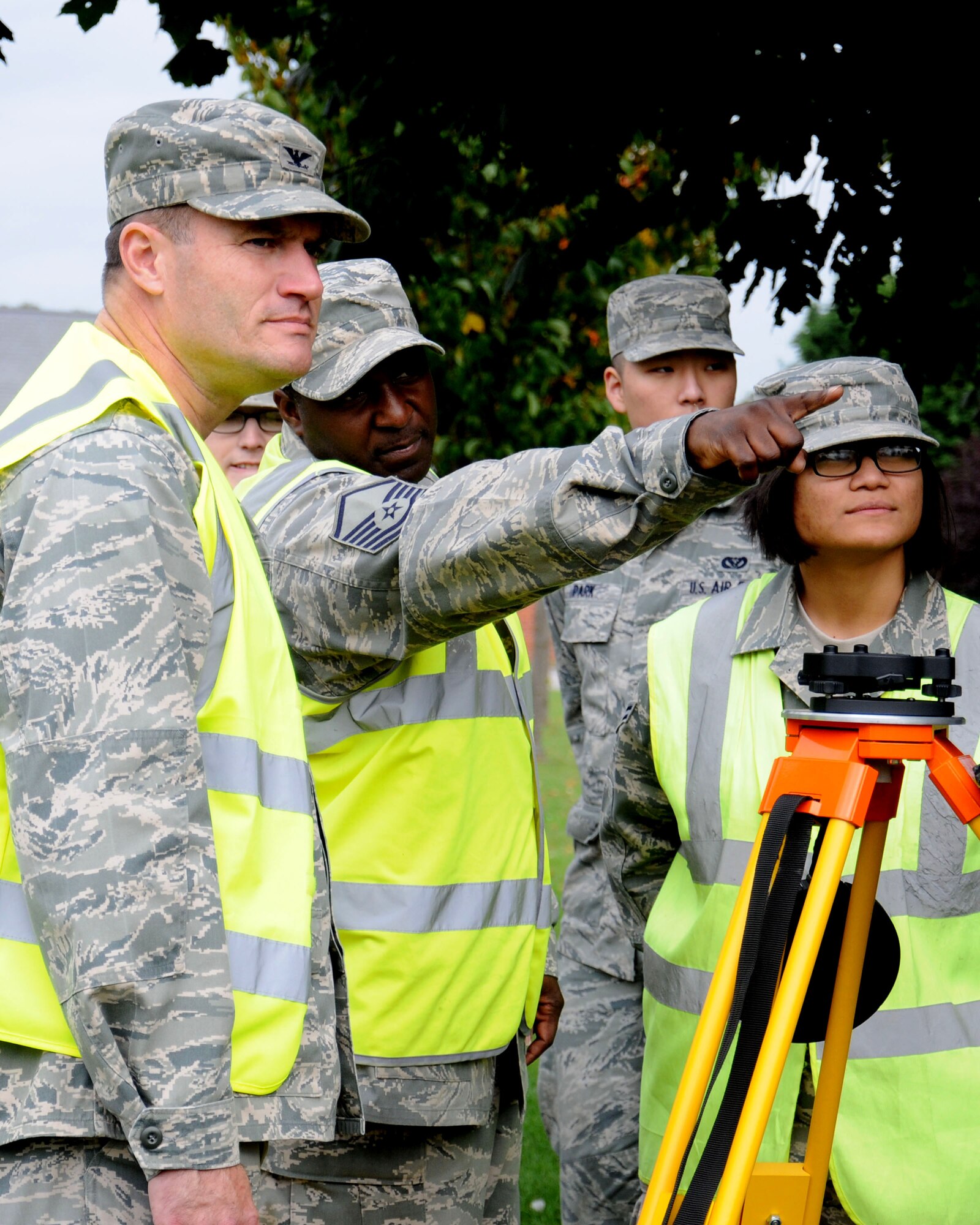 U.S. Air Force Master Sgt. Solomon Vincent, center, 100th Civil Engineer Squadron Programs Flight superintendent from Bladensburg, Md., explains how to use a geodimeter to U.S. Air Force Col. Kenneth T. Bibb Jr., 100th Air Refueling Wing commander, Oct. 9, 2013, on RAF Mildenhall, England. Members of the 100th ARW leadership visited the 100th CES Engineer Assistants shop as part of the “dirty jobs” program. Vincent explained how each time any building on base is constructed or modified, the 100th CES Engineer Assistants shop updates the associated floor plan and base map. (U.S. Air Force photo by Gina Randall/Released)
