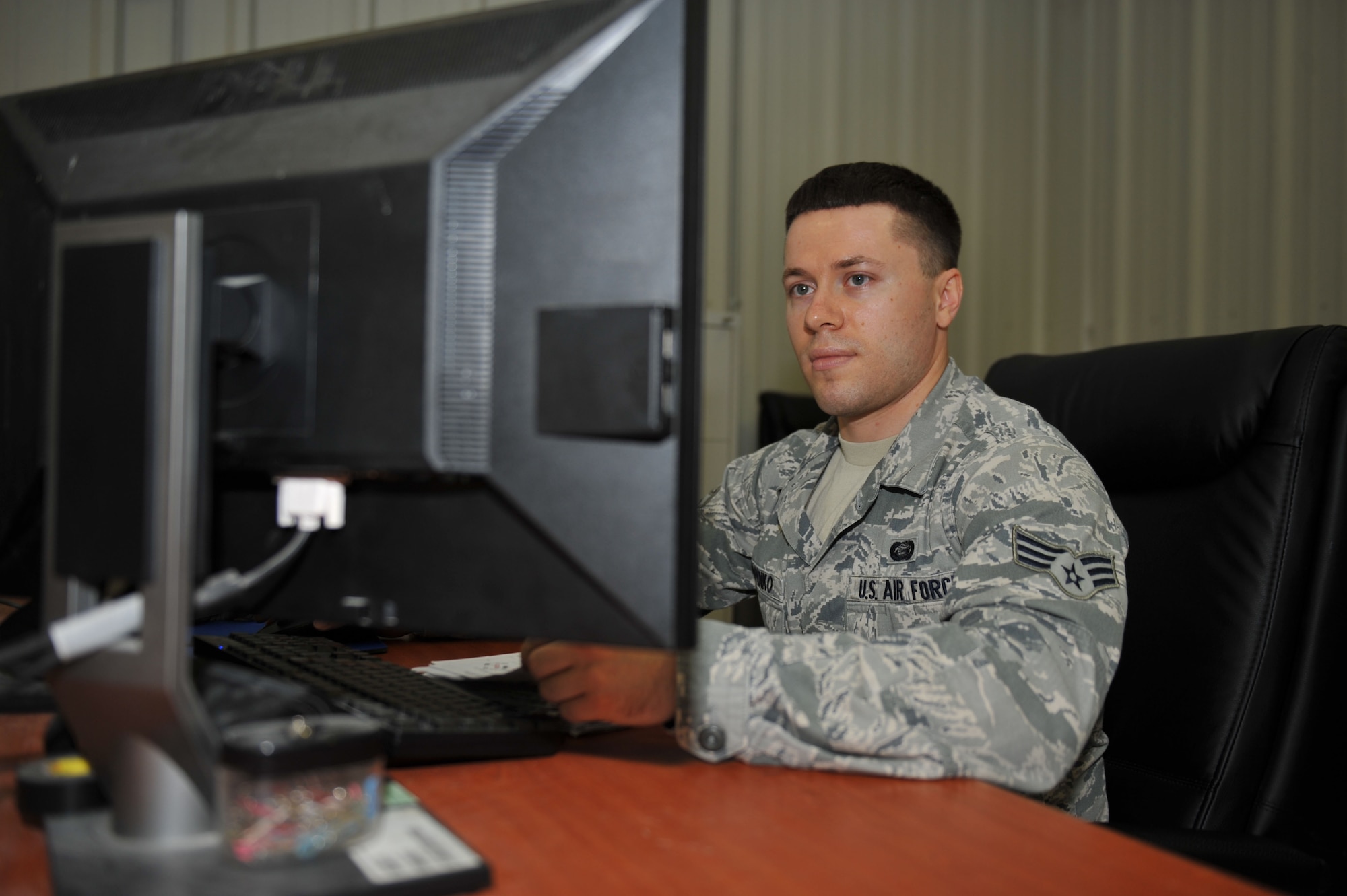 Senior Airman Eugene Philipenko deletes member information from the personnel database at the 379th Air Expeditionary Wing in Southwest Asia, Oct. 10, 2013. Personnel Support for Contingency Operations members maintain 100 percent accountability of all members assigned, forward deployed and departing the area of responsibility. Philipenko is a 379th Expeditionary Force Support Squadron PERSCO customer service representative deployed from Pope Army Airfield, Fort Bragg, N.C., and a Sacramento, Calif., native. (U.S. Air Force photo/Master Sgt. David Miller)