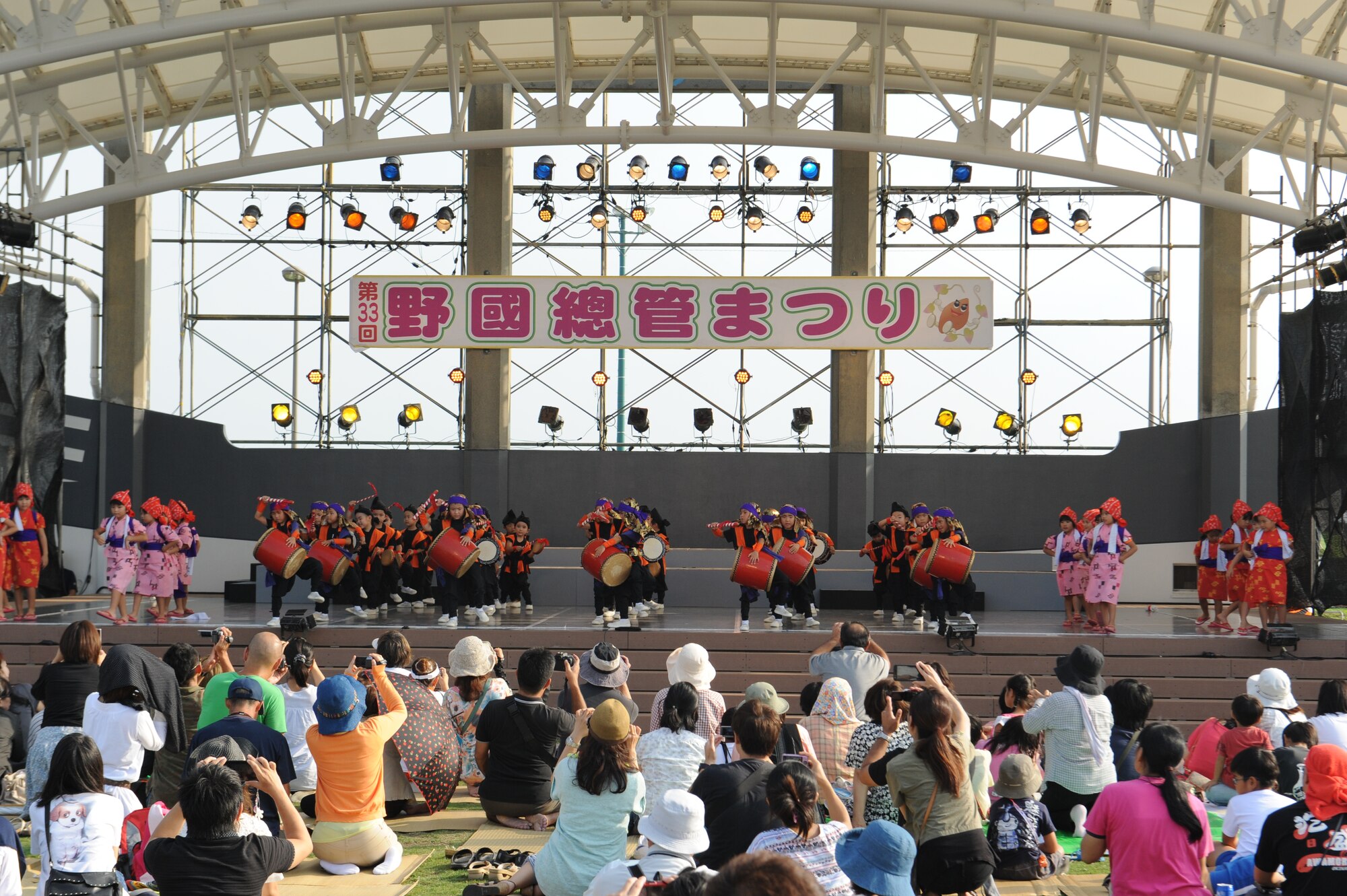 Members from across Okinawa watch children perform an Eisa dance at the Noguni Sokan Festival on Okinawa, Japan, Oct. 12, 2013. The festival showcased the local culture and Noguni Sokan, who brought the sweet potato from China to Okinawa. (U.S. Air Force photo by Senior Airman Malia Jenkins)