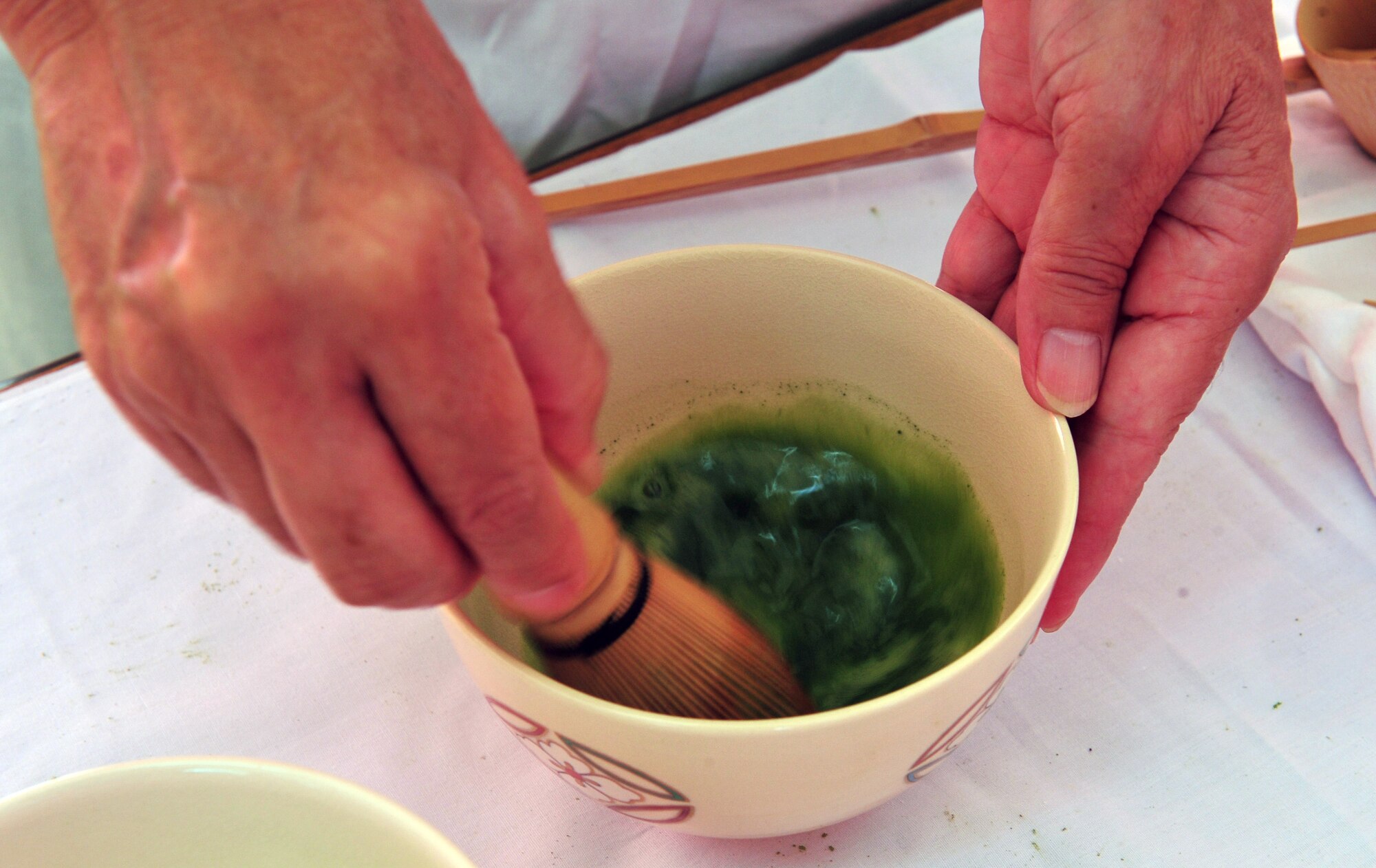 Tea is mixed for a traditional Japanese tea ceremony at the Noguni Sokan Festival in Kadena Town, Okinawa, Oct. 12, 2013. The traditional ceremony was one of several events during the festival which celebrates Noguni Sokan, who is credited for bringing sweet potatoes from China to Okinawa. (U.S. Air Force photo by Staff Sgt. Rachelle Coleman)
