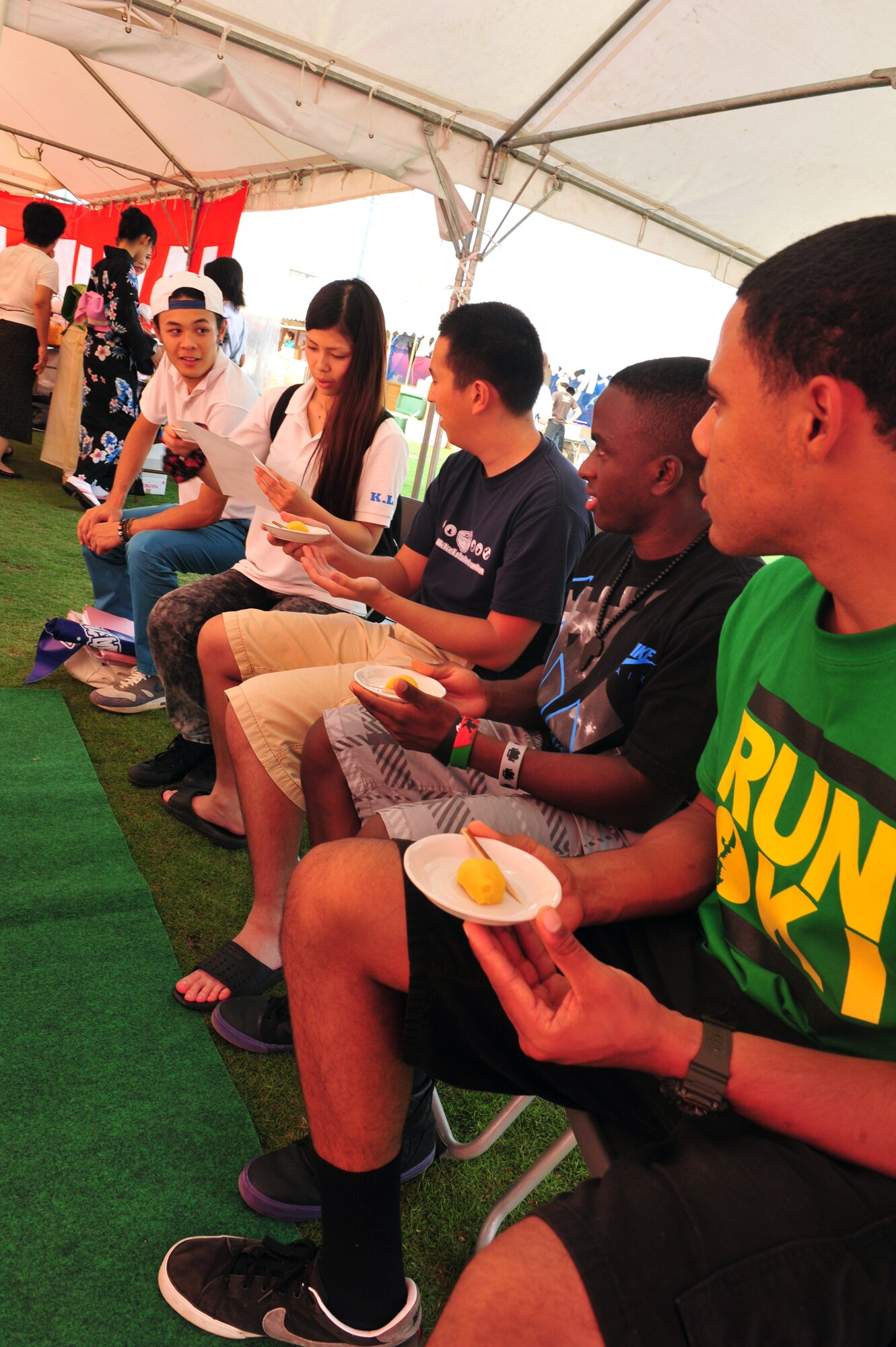 Kadena Language Institute students teach Airmen from the 18th Wing, Kadena Air Base, Japan, about traditional Japanese Tea ceremonies at the Noguni Sokan Festival in Kadena Town, Okinawa, Oct. 12, 2013. Every year Kadena Town celebrates its great man Noguni Sokan, who, in 1605, brought the sweet potato to Okinawa from China, saving the people from starvation. (U.S. Air Force photo by Staff Sgt. Rachelle Coleman)