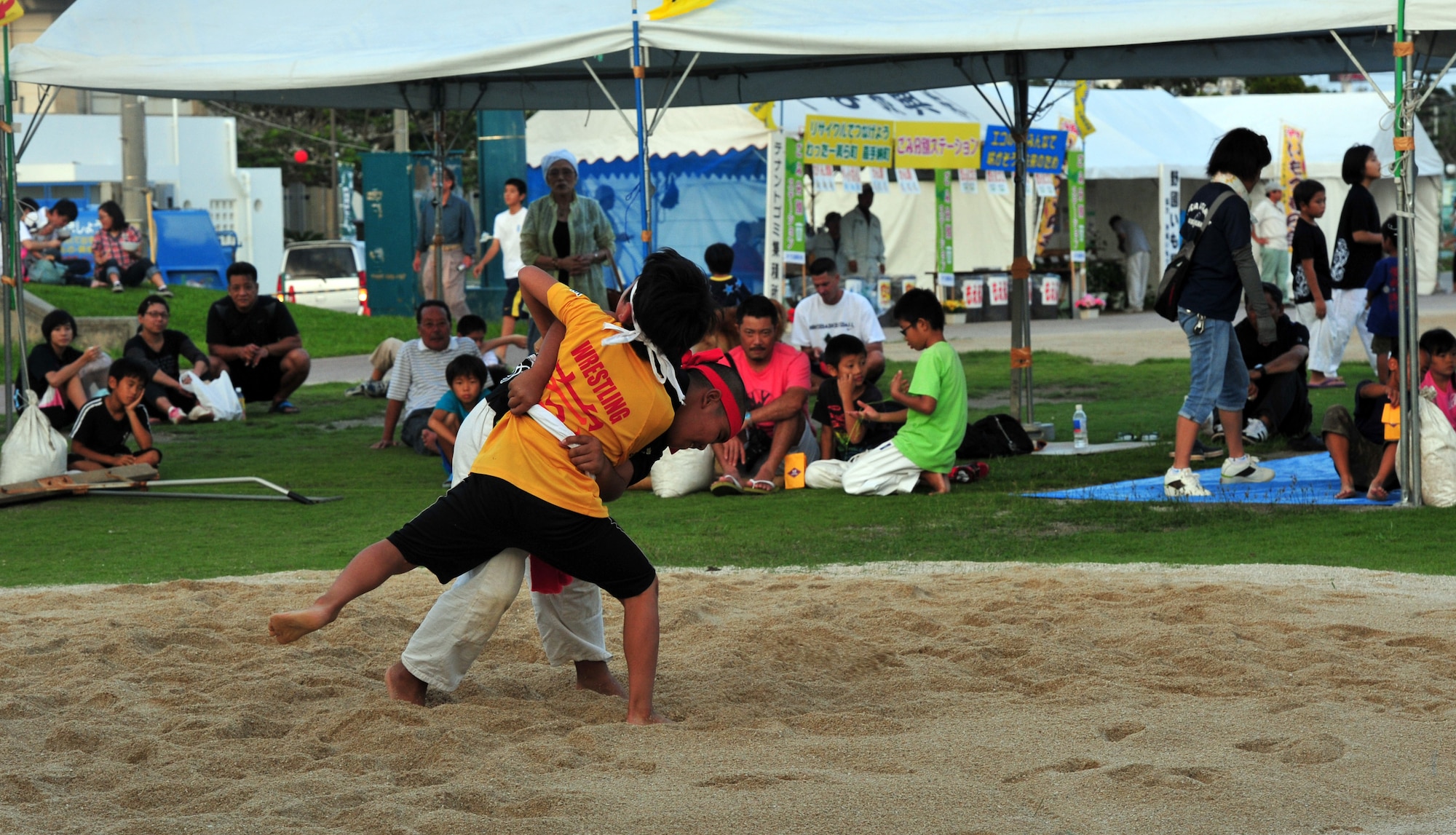 Children sumo wrestle during the Noguni Sokan Festival in Kadena Town, Okinawa, Oct. 12, 2013. Events included Kadena Town kids on stage, Tahitian dance, Dragon dance, numerous games and concluded with fireworks. (U.S. Air Force photo by Staff Sgt. Rachelle Coleman)