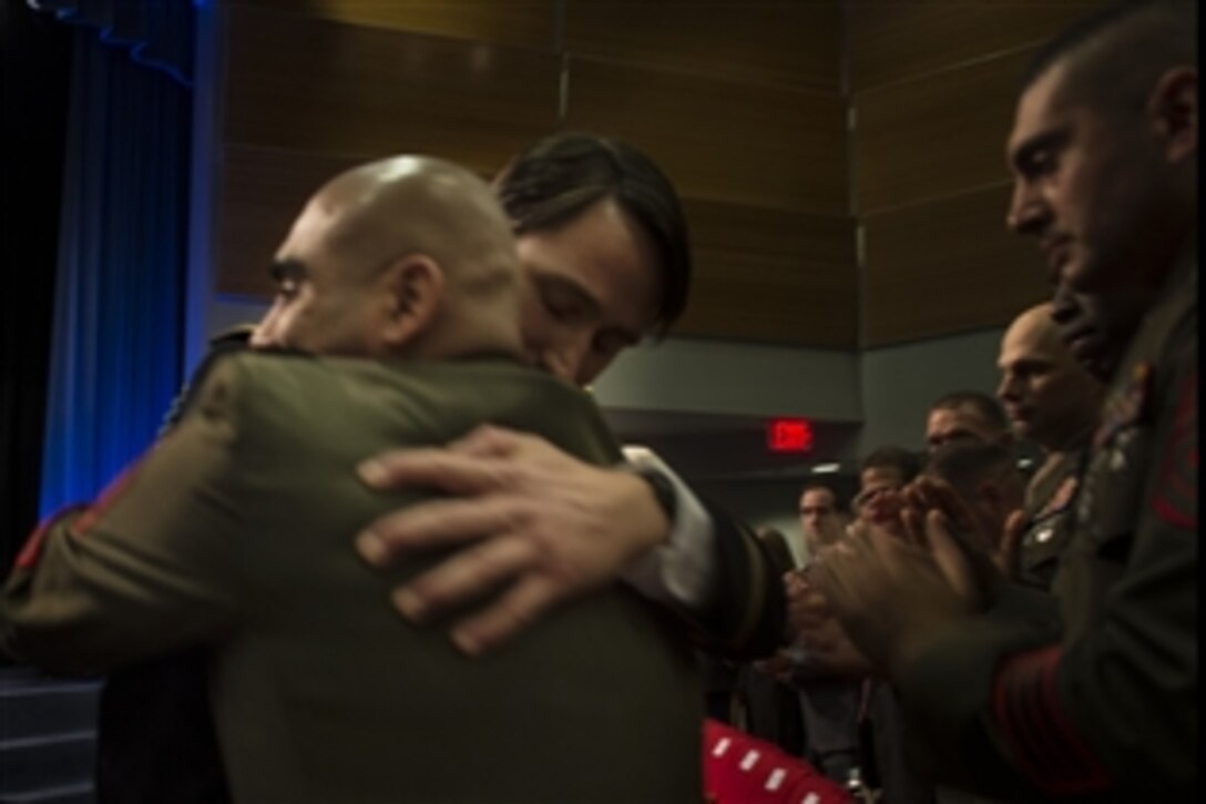 Former Army Capt. William D. Swenson embraces a Marine with whom he served in Afghanistan during the ceremony to induct him into the Hall of Heroes at the Pentagon, Oct. 16, 2013. Swenson received the medal for his efforts during combat operations in Afghanistan’s Kunar province, Sept. 8, 2009.