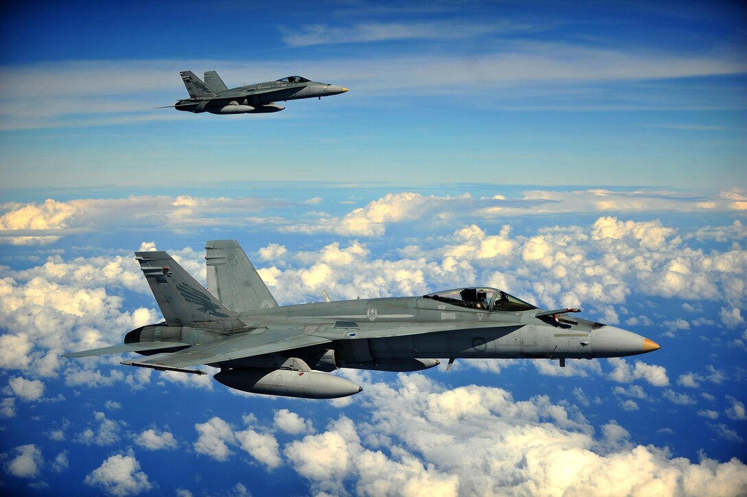 Two Royal Australian Air Force F/A-18 Hornets form up in preparation to conduct an air refuel while participating in Cope North 13 Feb. 13, 2013, near Anderson Air Force Base, Guam. The F/A-18 is a multi-role fighter designed for both air-to-air and air-to-ground missions. Cope North is an annual air combat tactics, humanitarian assistance and disaster relief exercise designed to increase the readiness and interoperability of the U.S. Air Force, Japan Air Self-Defense Force and Royal Australian Air Force. (U.S. Air Force photo/Senior Airman Matthew Bruch)
