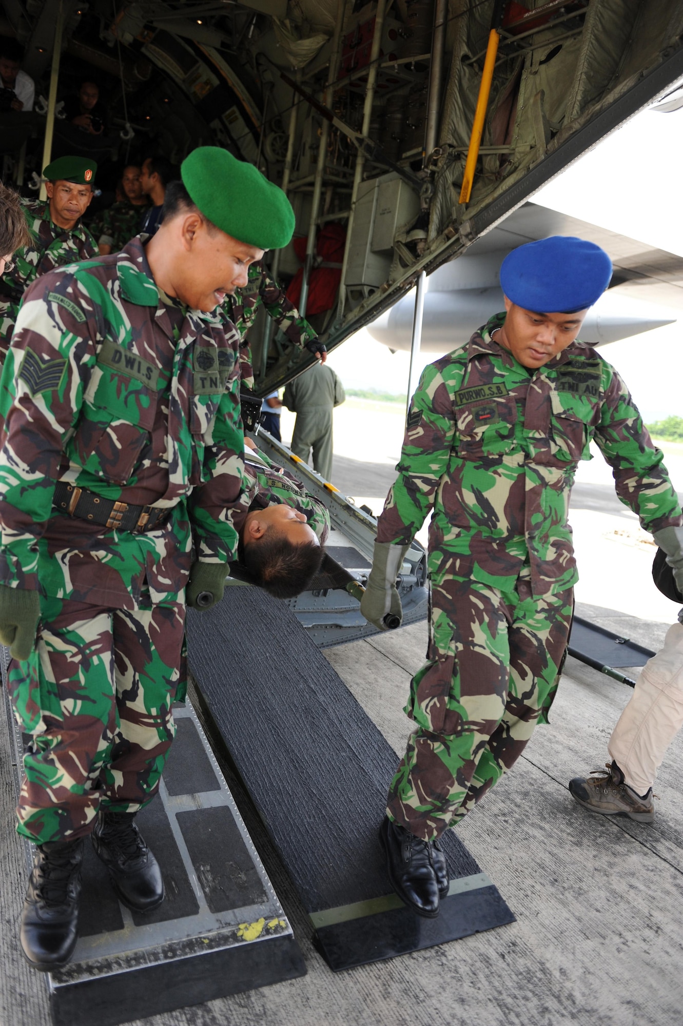 Participants of an aeromedical evacuation subject-matter expert exchange carry a simulated patient out of a C-130 Hercules during Pacific Angel 13-2 April 24, 2013, at Yogyakarta, Indonesia. PACANGEL is a joint and combined humanitarian assistance exercise held in various countries several times a year and includes medical, dental, optometry, engineering programs and various subject-matter expert exchanges. (U.S. Air Force photo/Airman 1st Class Kia Atkins)