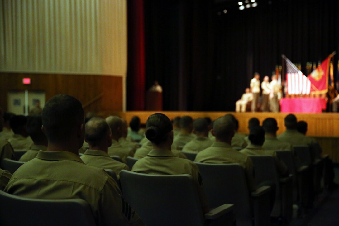 More than 120 Sergeants Course Class 6-13 graduates walk on stage to receive their awards during a graduation ceremony at the base theater aboard Marine Corps Base Camp Lejeune, Oct. 8. Among the usual challenges the students faced, the government shutdown forced some student’s parent commands to cancel their temporary additional duties per diem and return to their everyday jobs.