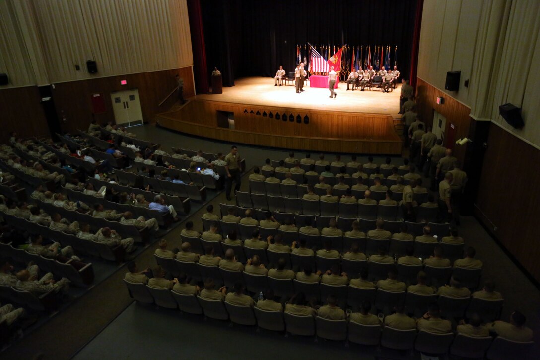 More than 120 Sergeants Course Class 6-13 graduates walk on stage to receive their awards during a graduation ceremony at the base theater aboard Marine Corps Base Camp Lejeune, Oct. 8. Among the usual challenges the students faced, the government shutdown forced some student’s parent commands to cancel their temporary additional duties per diem and return to their everyday jobs.