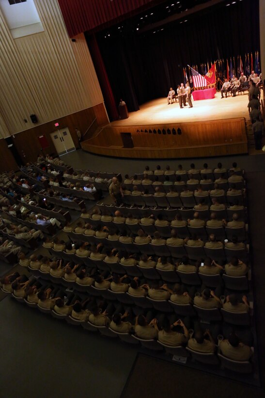 More than 120 Sergeants Course Class 6-13 graduates walk on stage to receive their awards during a graduation ceremony at the base theater aboard Marine Corps Base Camp Lejeune, Oct. 8. Among the usual challenges the students faced, the government shutdown forced some student’s parent commands to cancel their temporary additional duties per diem and return to their everyday jobs.