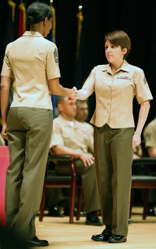 Sgt. Alicia R. Leaders, a combat correspondent with Headquarters and Headquarters Squadron aboard Marine Corps Air Station New River, receives her graduation award during the Sergeants Course Class 6-13 graduation at the base theater aboard Marine Corps Base Camp Lejeune, Oct. 8. The graduates were Marines comprised from 52 different military occupational specialties.