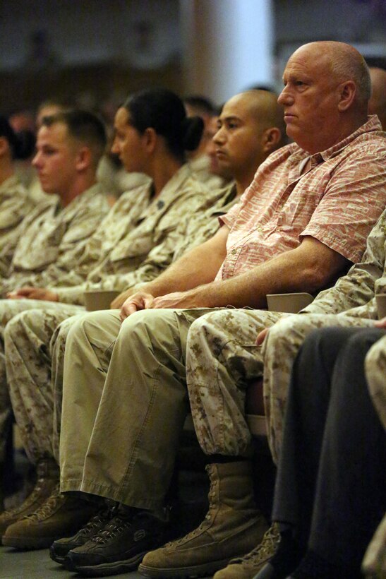 Fellow Marines and family members watch as the graduates receive their awards during the graduation ceremony of Sergeants Course Class 6-13 at the base theater aboard Marine Corps Base Camp Lejeune, Oct. 8. Sergeants Course is an eight week professional education course in which the students spend 30 hours learning administration, 51.5 hours learning war fighting and 111 hours in leadership training.