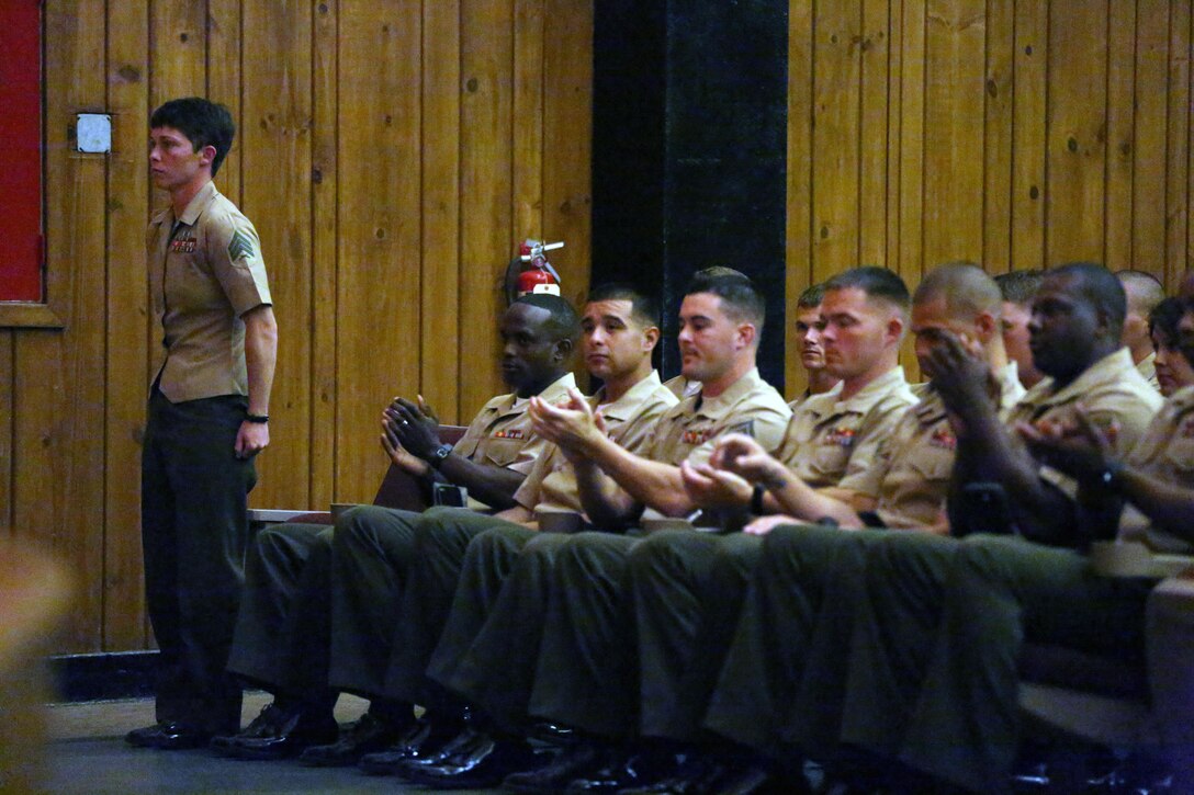 Sgt. Patricia A. Aliff, a Papa Company, 4th Recruit Training Battalion, Marine Corps Recruit Depot Parris Island drill instructor, receives a round of applause from her classmates during the Sergeants Course Class 6-13 graduation at the base theater aboard Marine Corps Base Camp Lejeune, Oct. 8. Aliff was the first female Marine to be nominated as both Gung Ho recipient and Honor Graduate.
