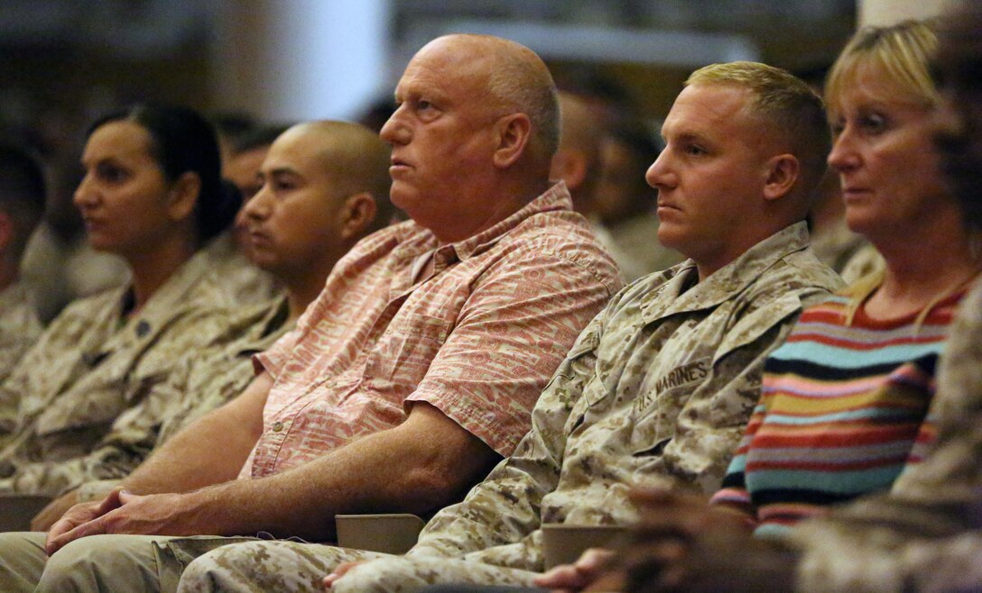 Fellow Marines and family members watch as the graduates receive their awards during the graduation ceremony of Sergeants Course Class 6-13 at the base theater aboard Marine Corps Base Camp Lejeune, Oct. 8. Sergeants Course is an eight week professional education course in which the students spend 30 hours learning administration, 51.5 hours learning war fighting and 111 hours in leadership training.