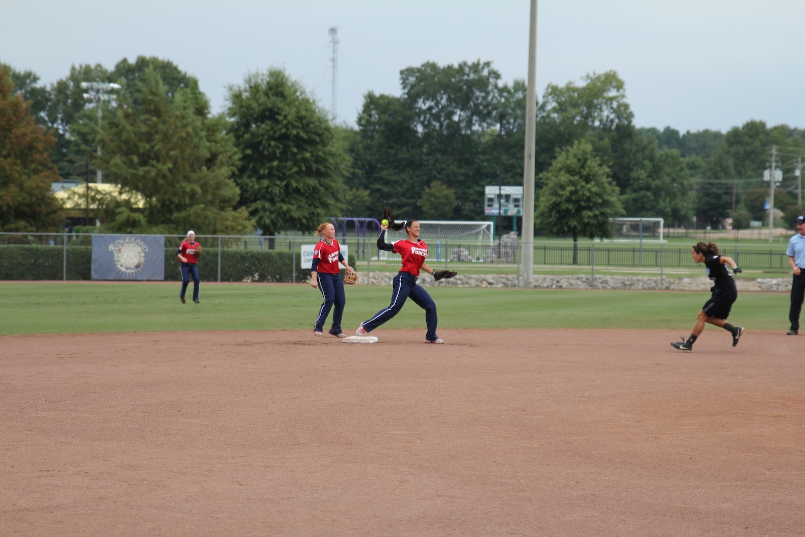 MA3 Shasta Rodriguez, Navy Operational Support Center, NC (Navy) (Center) with SPC Miranda Campbell, Camp Casey, Korea (Army) (left) turn a double play at the 2013 ASA National Softball Championship in Ridgeland, MS 26-30 September.  The Armed Forces Women took their 7th consecutive silver medal at the USA National Championship