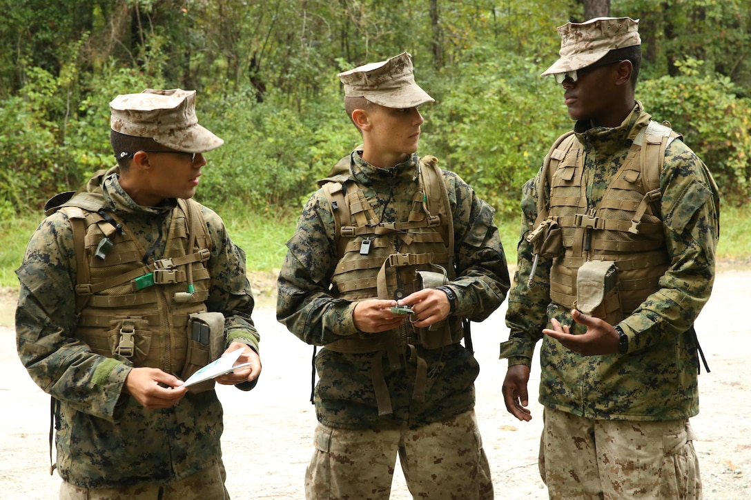 Pfc. Maximo Lieiano, Pvt. Matthew Ciccone and Pvt. Darrell Moore, Marines with 4th Platoon, Company I, Marine Combat Training Battalion, plan their route during the MCT Land Navigation Course at Verona Loop aboard Marine Corps Base Camp Lejeune, Oct. 9. The Marines are scheduled to graduate, Oct. 22