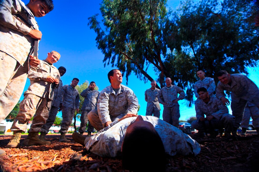 Petty Officer 2nd Class Andrew Owensby, lead instructor of the combat life saver course with I Marine Expeditionary Force, Advisory Training Cell, demonstrates trauma medicine techniques aboard Camp Pendleton, Calif., Oct. 8. The course prioritizes survivability on the battlefield as second only to killing the enemy.