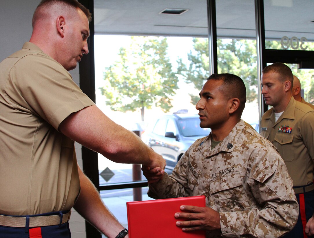 Staff Sgt. David Martinez shakes hands with  Maj. Lance C. Day at Recruiting Station Salt Lake City after receiving his recruiting ribbon Oct. 17, 2013. This was Martinez's final day with the recruiting command.  