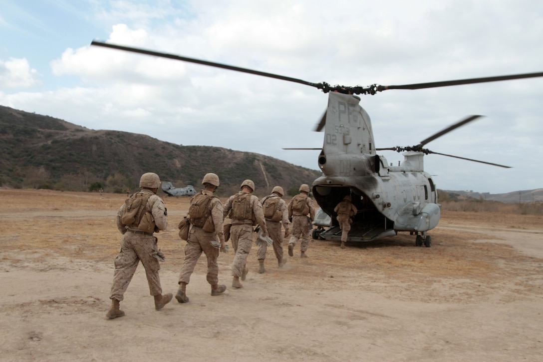 MARINE CORPS BASE CAMP PENDLETON, Calif. -- Marines serving with Kilo Company, 3rd Battalion, 5th Marine Regiment, board a CH-46 Sea Knight helicopter during a fast rope training exercise here, Oct. 9, 2013. Fast roping allows Marines to quickly enter an area without the need for a landing zone. The technique is often employed during raids, enabling forces to rapidly secure an objective. The battalion is scheduled to deploy next spring as the battalion landing team for the 31st Marine Expeditionary Unit in Okinawa, Japan. Kilo Co. is currently assigned as the helicopter element within the battalion landing team.