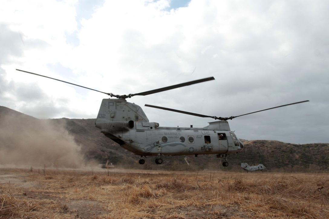 MARINE CORPS BASE CAMP PENDLETON, Calif. – Two CH-46 Sea Knight helicopters lift off carrying Marines from Kilo Company, 3rd Battalion, 5th Marine Regiment, during fast rope training here, Oct. 9, 2013. The helicopters lowered ropes that Marines used to slide down and enter their objective area. Fast roping enables Marines to rapidly deploy to hostile or inaccessible terrain without requiring aircraft to land. Kilo Co. is scheduled to deploy with the battalion as part of the 31st Marine Expeditionary Unit where they will serve as the helicopter company.