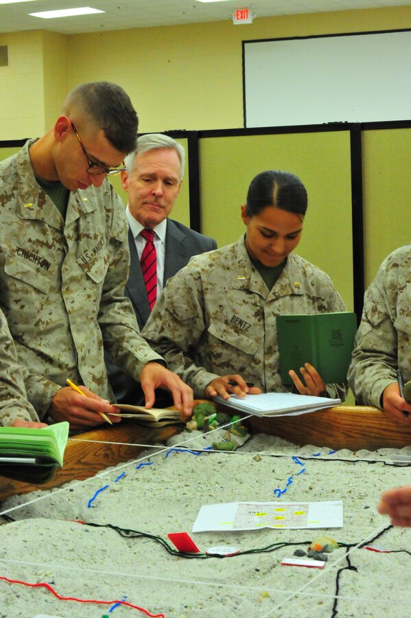 Ray Mabus, secretary of the Navy, watches Fox Co. Marines review tactics during a tour at The Basic School on Oct. 7, 2013. During his tour, Mabus ate lunch with lieutenants and watched a Marine Corps Martial Arts presentation.