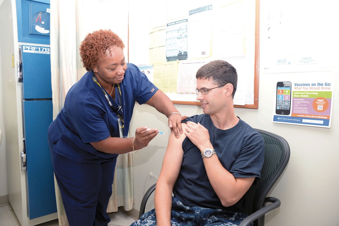 Navy Lt. Jason Slingerland, a new physician at Naval Branch Health Clinic Albany, receives a flu shot Oct. 10 at the clinic from Sheryl Taylor, a certified medical assistant.