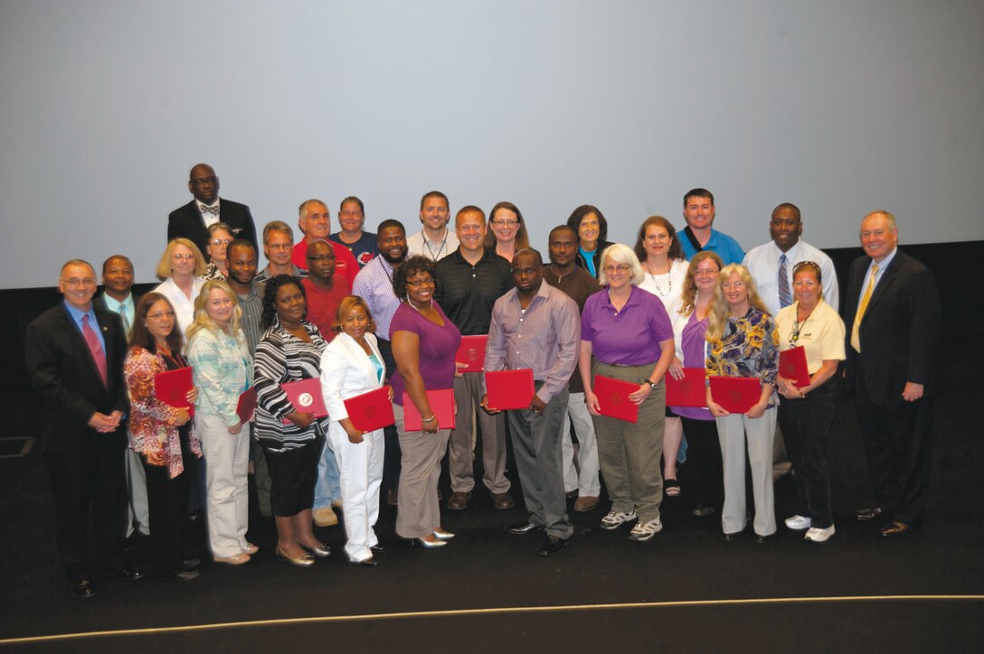 A group of Marine Corps Logistics Command and Marine Corps Logistics Base Albany civilian-Marines pose together after receiving certificates during the Civilian Career Leadership Development graduation ceremony, Sept. 18 at the Base Theater. One of the goals of the Civilian Career and Leadership Program is to improve leadership skills and competencies of all civilian-Marines. 