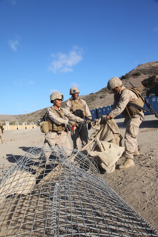 Marines with Alpha Company, 7th Engineer Support Battalion, 1st Marine Logistics Group, tear down HESCO bunkers during a Marine Readiness Exercise, a culminating event designed to evaluate the skills learned during two months of pre-deployment training aboard Camp Pendleton, Calif., Oct. 9, 2013. The Marines had a chance to demonstrate their ability to operate in high-risk situations and carry out tasks efficiently both individually and as a unit. Some of the skills included convoy operations, immediate action drills, demilitarization exercises, cross training and teamwork. 