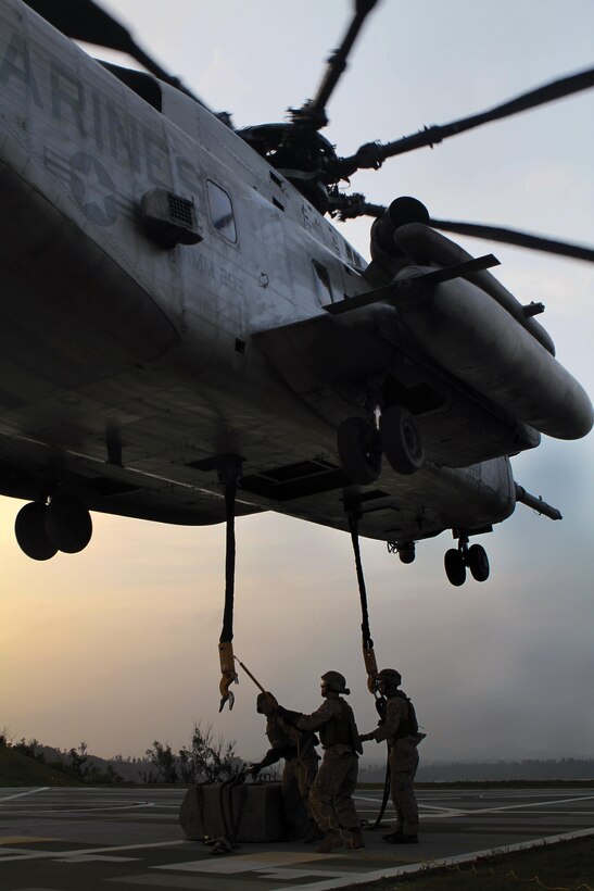Landing support specialists attach a 7,000-pound cement block to a CH-53E Super Stallion helicopter during dual-point external training at Landing Zone Swan in the Central Training Area May 10. The training consisted of transporting the cement block to different locations around the landing zone,
with the block simulating a Humvee. The helicopter can carry externally slung loads up to 36,000 pounds and is used for cargo loads like military vehicles, supplies, food and water. The helicopter is with Marine Medium Helicopter Squadron 265 (Reinforced), Marine Aircraft Group 36, 1st Marine Aircraft
Wing, III Marine Expeditionary Force.