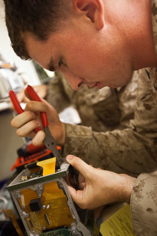 Lance Cpl. Maxwell B. Loomis, a ground radio repairman with Combat Logistics Battalion 31, 31st Marine Expeditionary Unit, and a native of Pacheco, Calif., replaces the battery ribbon cable of an RT-1523F radio during the unit’s “Maintenance Stand-down” here, Oct. 17. The initiative occurs before and after every 31st MEU deployment, ensuring every vehicle and piece of equipment is inspected and repaired in preparation for the next patrol or mission. The 31st MEU is the Marine Corps’ force in readiness for the Asia-Pacific region and is the only continuously forward-deployed MEU. 