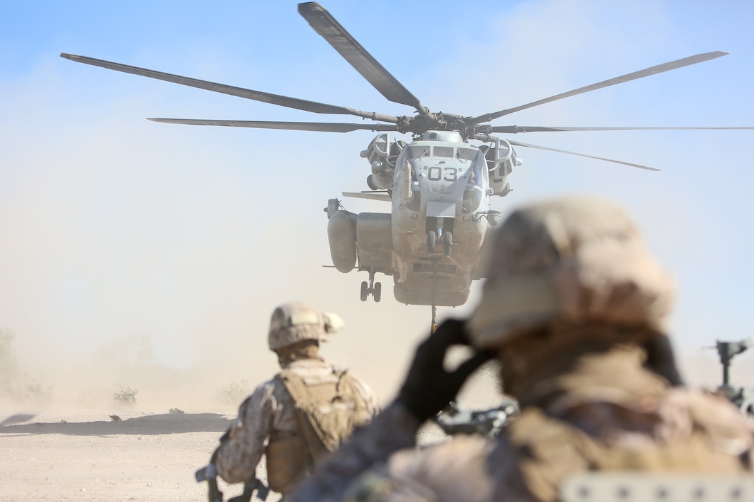 Marines with Landing Support Company, Combat Logistics Regiment 17, 1st Marine Logistics Group, prepare to attach equipment to a CH-53E Super Stallion during a Helicopter Support Team operation, supporting Weapons and Tactics Instructor Course 1-14, in Yuma, Ariz., Oct. 5, 2013. An HST allows the rapid deployment of weapons systems, equipment and supplies across long distances through rotary wing aircraft. 