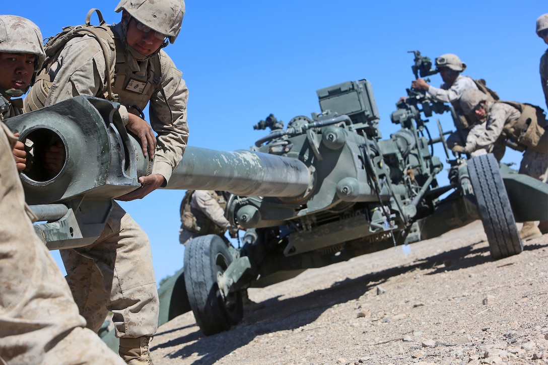 Marines with Golf Battery, 2nd Battalion, 11th Marine Regiment, 1st Marine Division, conduct a mock firing drill with an M777 Howitzer during Weapons and Tactics Instructor Course 1-14 near Yuma, Ariz., Oct. 5, 2013. A Helicopter Support Team with Landing Support Company, Combat Logistics Regiment 17, 1st Marine Logistics Group, rigged the artillery pieces to a CH-53E Super Stallion in order for them to be transported to the training site. 