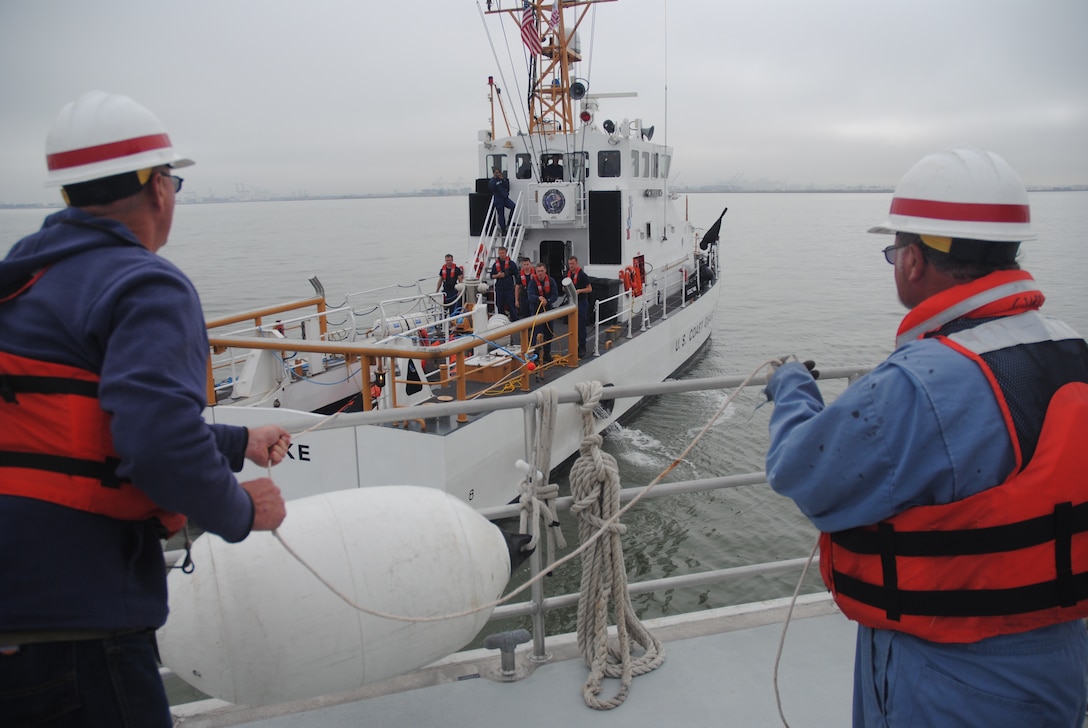 U.S. Army Corps of Engineers San Francisco District crew members Steve Roehner, left, and Rick Curry secure lines during an emergency towing exercise with Bay Area Coast Guardsmen July 9. 