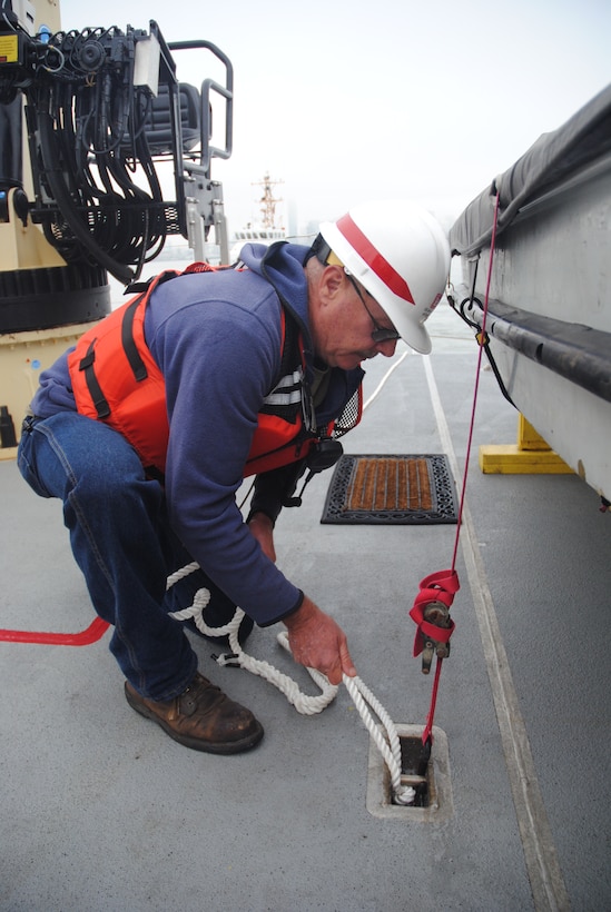 U.S. Army Corps of Engineers San Francisco District crew member Steve Roehner ties down a line during an emergency towing exercise with Bay Area Coast Guardsmen July 9.