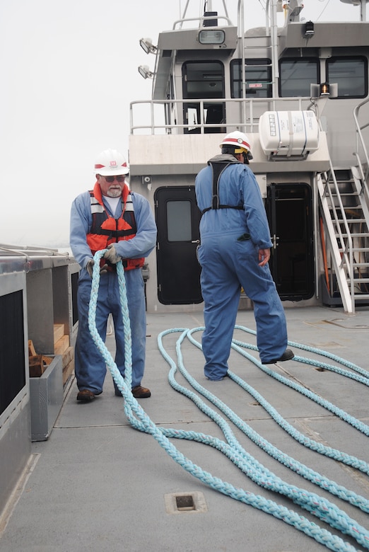 Rick Curry prepares the lines on the deck of the Dillard vessel. 