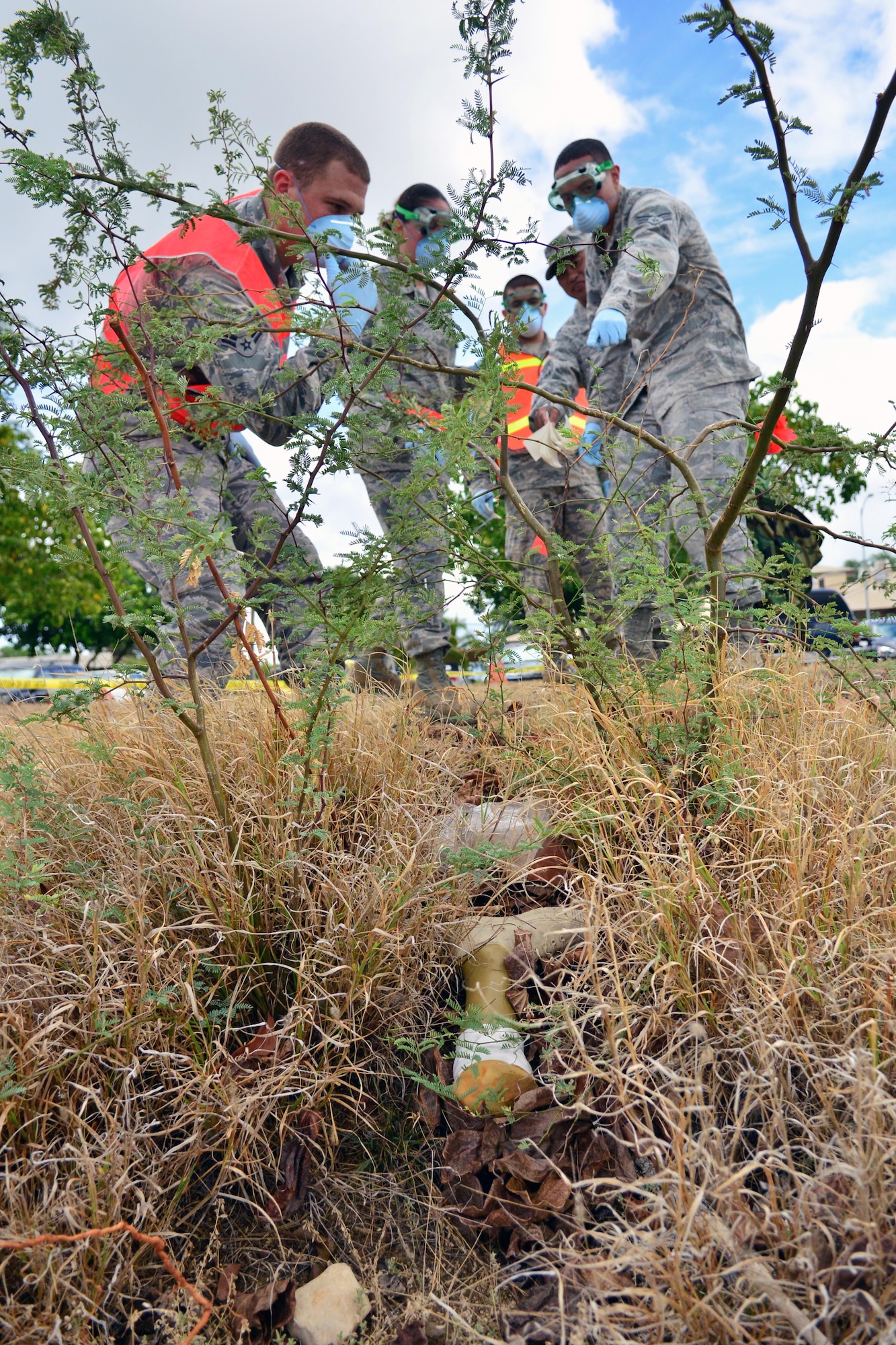 Search and recovery team members discover a "leg" during a recent training exercise held Sept. 26 on Hickam Beach. The purpose of the search and recovery team is to respond to military-related incidents on base, including military vehicle, aircraft mishap and mass casualty incidents, if and when they occur. (U.S. Air Force photo by Senior Airman Christopher Stoltz)