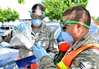 Members of the search and recovery team collect and tag evidence found during a recent training exercise. The purpose of the search and recovery team is to respond to military-related incidents on base, including military vehicle, aircraft mishap and mass casualty incidents, if and when they occur. (U.S. Air Force photo by Senior Airman Christopher Stoltz)