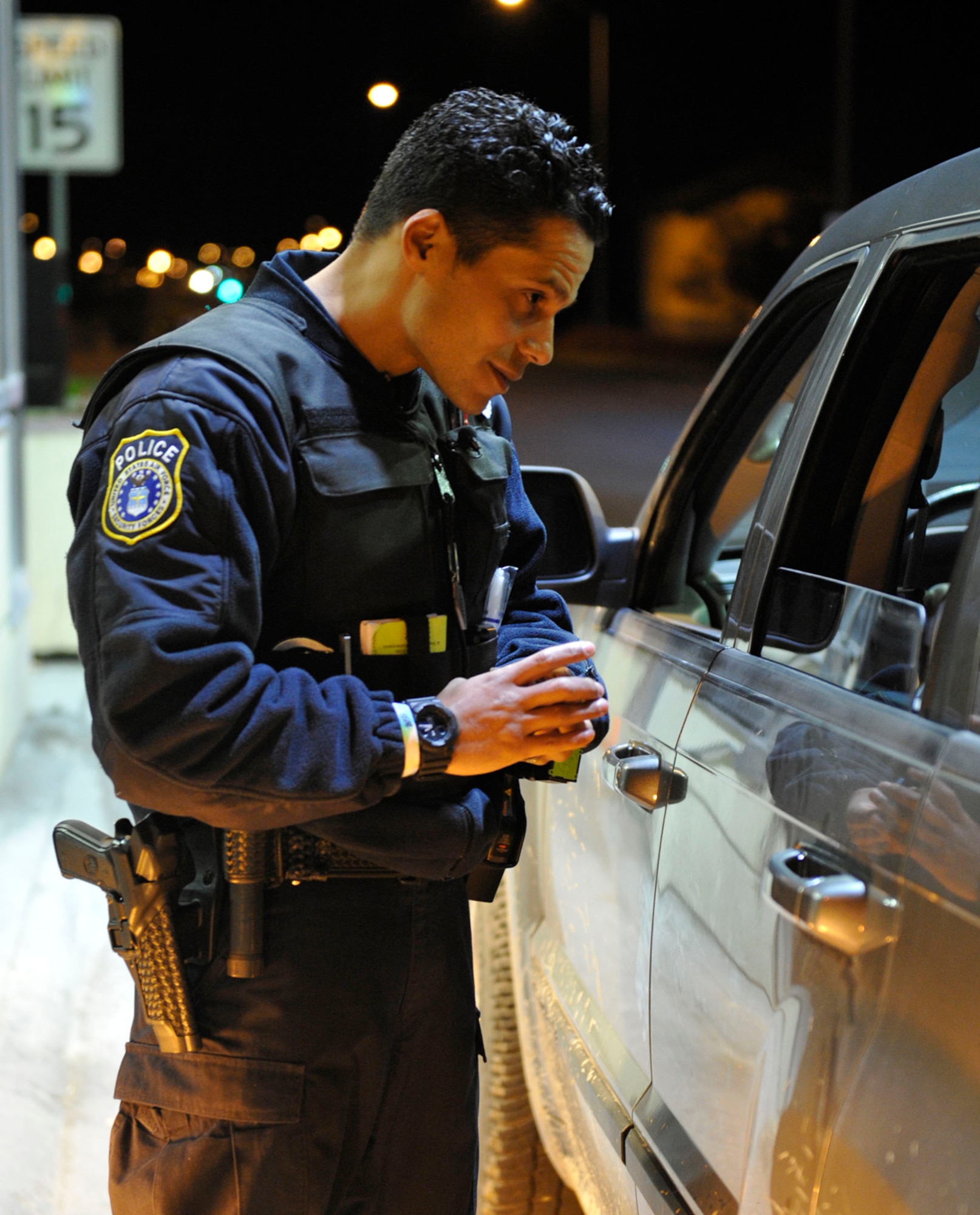 Edwin Hernandez Jr., Joint Base Elmendorf-Richardson civilian police officer, talks with a driver during Operation Nighthawk on JBER, Oct. 12. Hernandez checked the driver for signs of intoxication, such as bloodshot eyes and slurred words. (U.S. Air Force photo/Airman 1st Class Tammie Ramsouer)